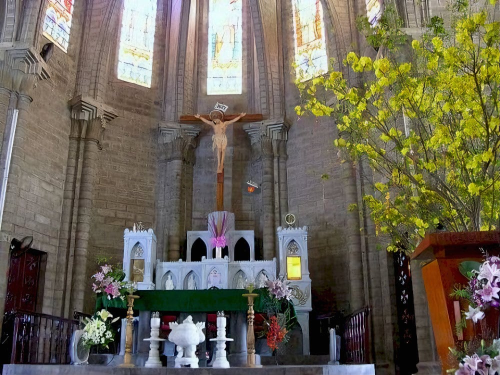 The interior boasts intricately designed marble altars and religious statues 